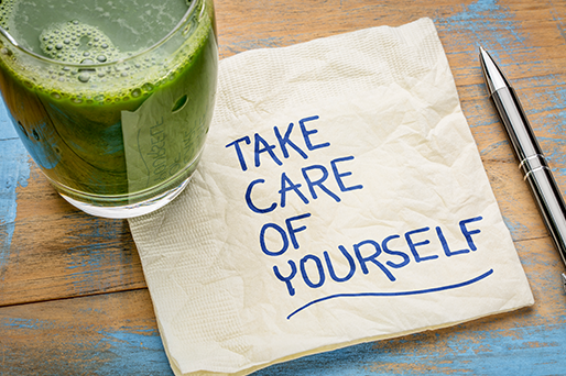 glass of green juice on napkin with take care of yourself note