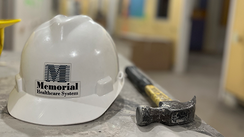 Memorial Healthcare System construction hat next to hammer