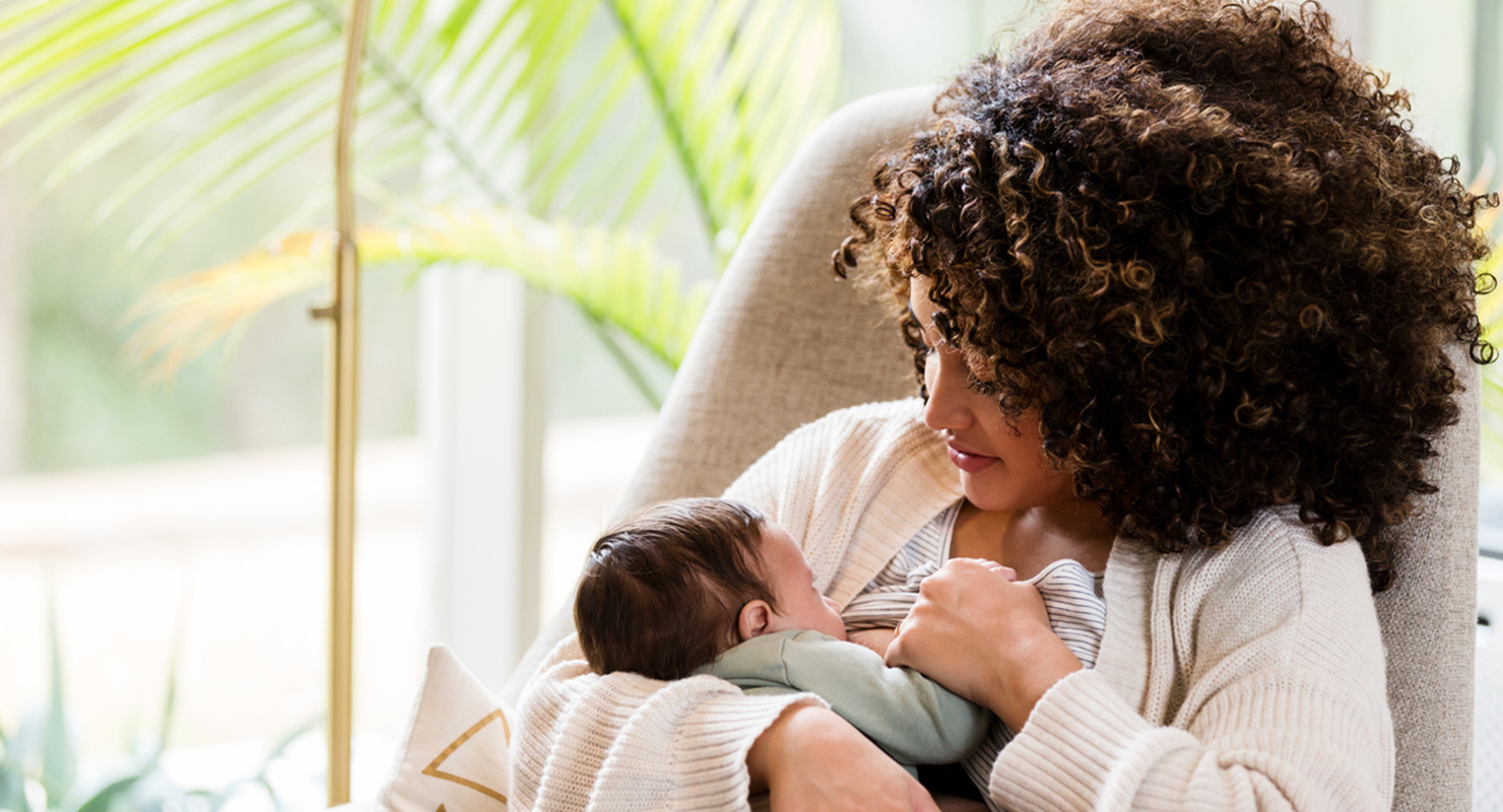 mom breastfeeding baby in chair thumbnail
