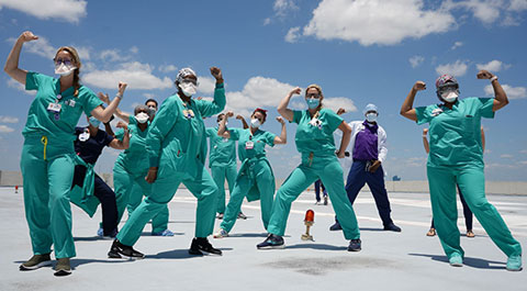 Employees wearing masks celebrating