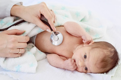 newborn with stethoscope on chest