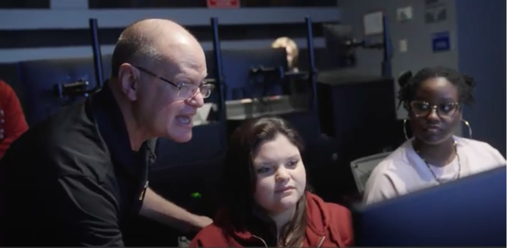 Barry, working with his students