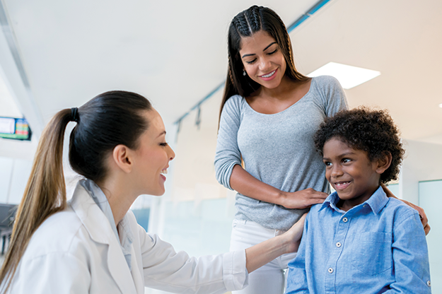 pediatrician greeting mom and young son