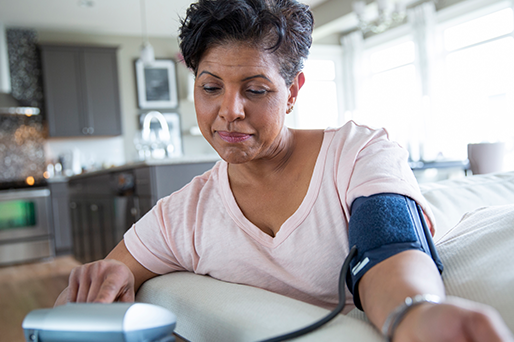 woman checking blood pressure at home