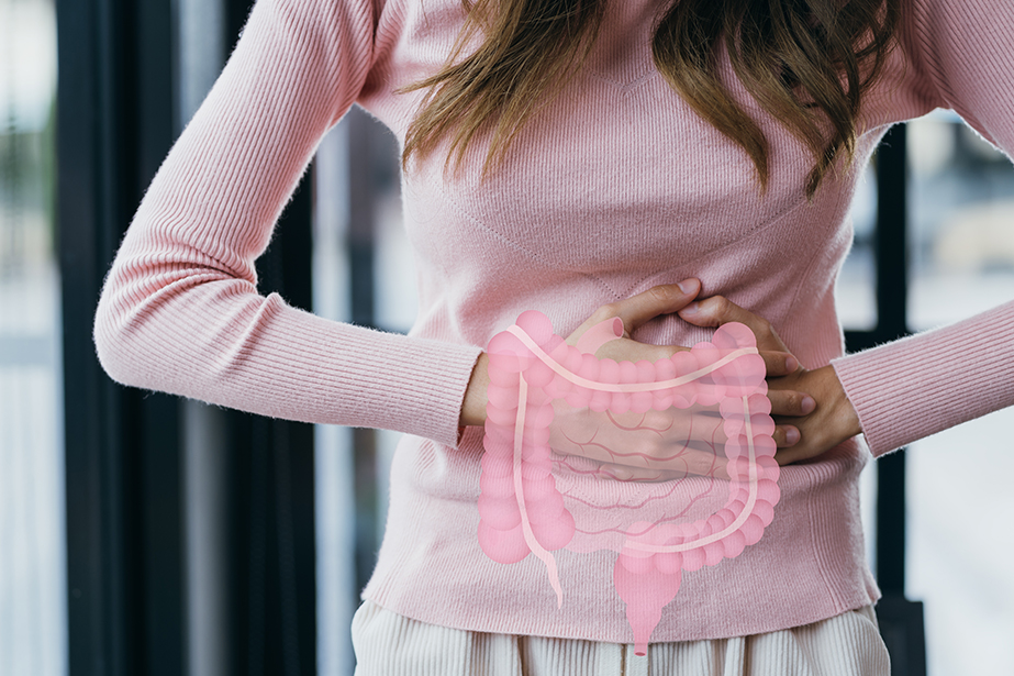 Woman hands touching on stomach with intestine virtual icon, probiotics food for gut health, colon cancer, bowel inflammatory.