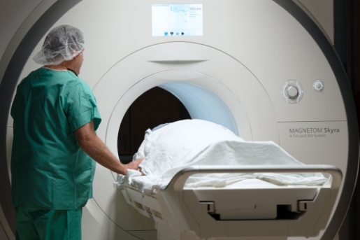 Healthcare provider with patient on MRI