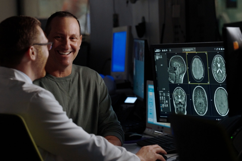Doctor Buttrick with patient reviewing neuroimages