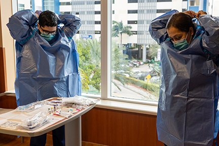 Clinicians putting on PPE