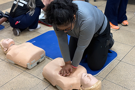 Woman doing CPR on dummy