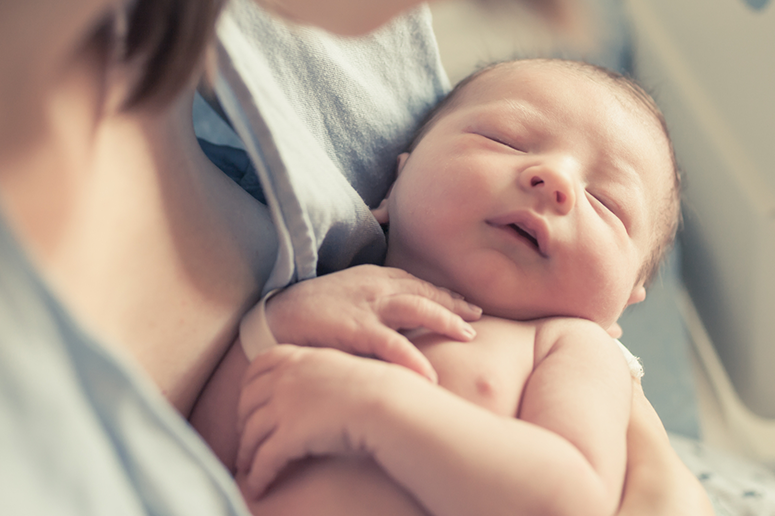 mom holding sleeping newborn
