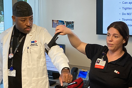 Dr. Jerry Borgella and Candice Pineda, RN, demonstrating a tourniquet