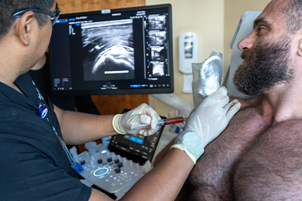 Dr. Negron injecting PRP into Kyrylo's injured shoulder