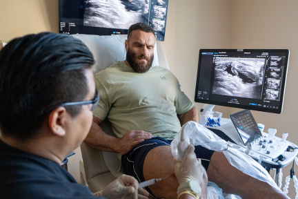 Dr. Negron injecting PRP into Kyrylo's injured knee