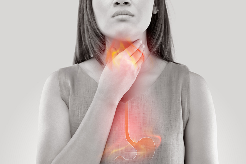 woman holding throat GERD acid reflux heartburn
