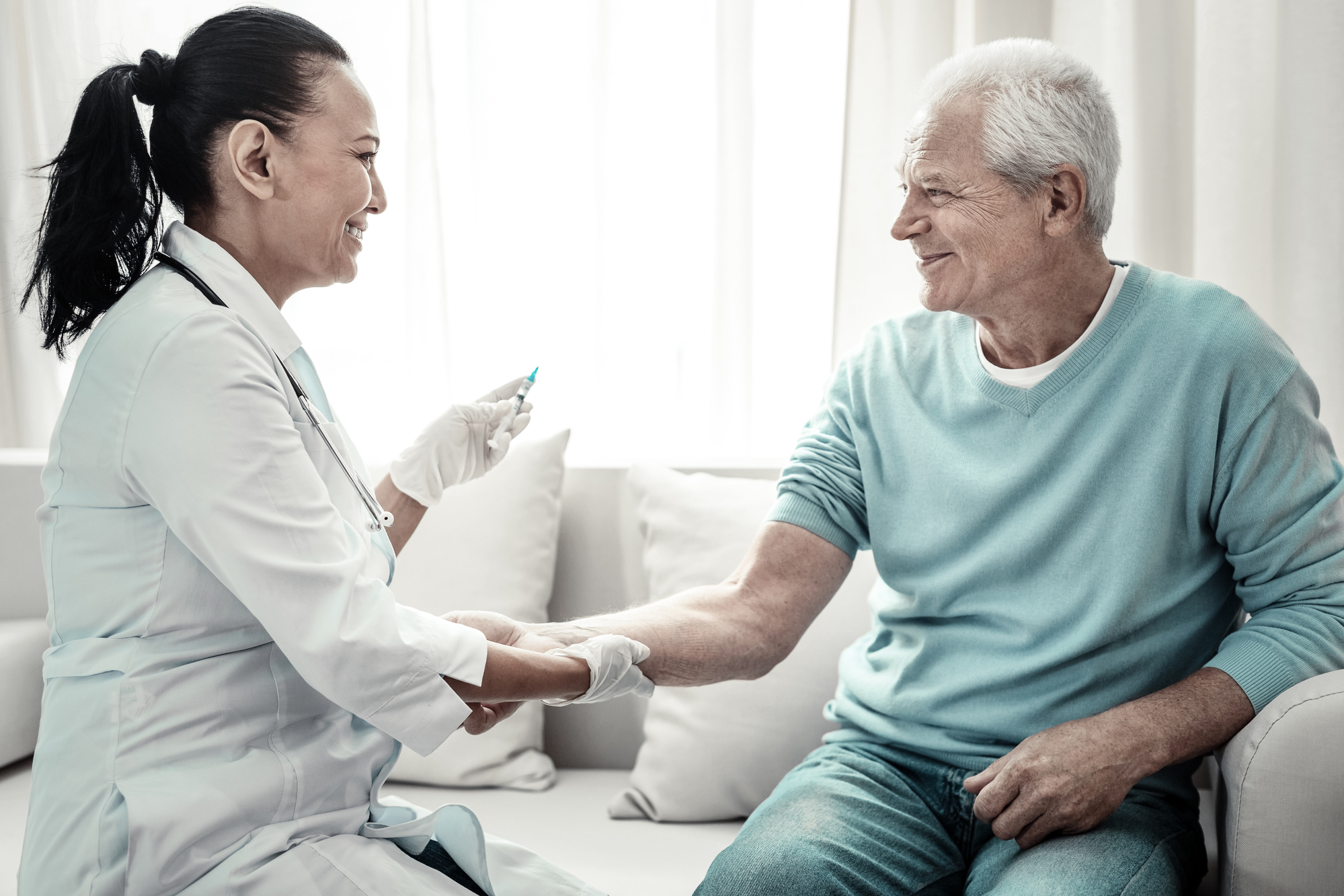 nurse injecting man at home