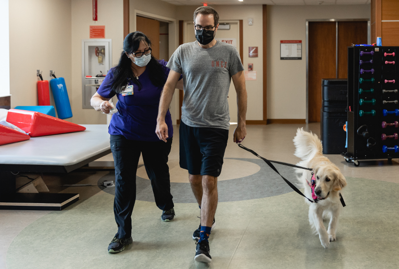 brett rose with physical therapist and pet therapy dog mesa
